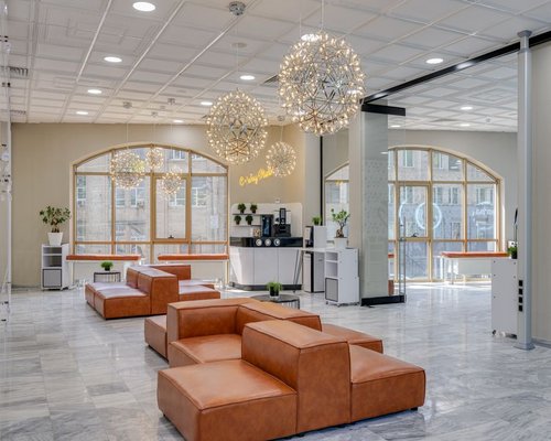 A neat reception or meeting area in a modern Mexican coworking building with comfortable seating